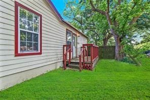 view of yard featuring fence and a deck