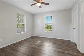 unfurnished bedroom with multiple windows, ceiling fan, and wood finished floors