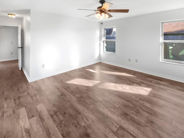 spare room with a ceiling fan, baseboards, and wood finished floors