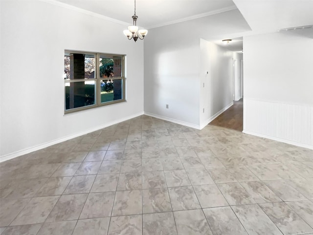 spare room with a chandelier, wainscoting, crown molding, and baseboards