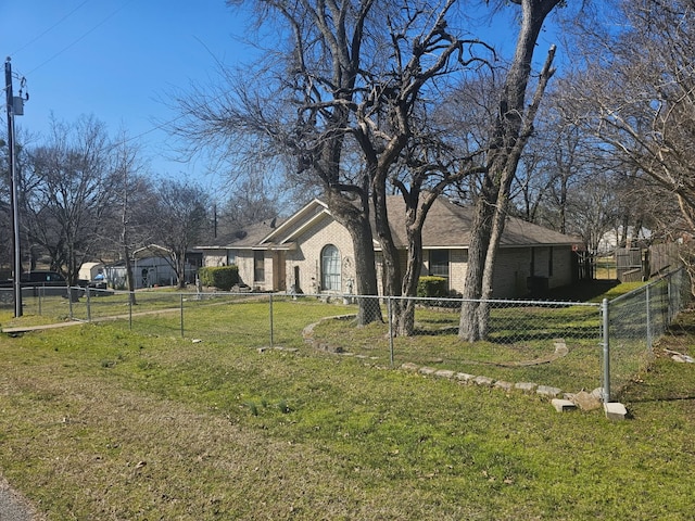 view of front of property with a front yard, brick siding, and fence