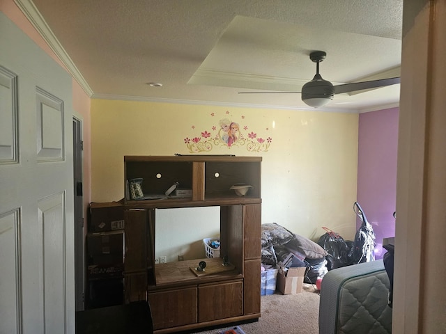 carpeted bedroom with a textured ceiling, ceiling fan, and ornamental molding