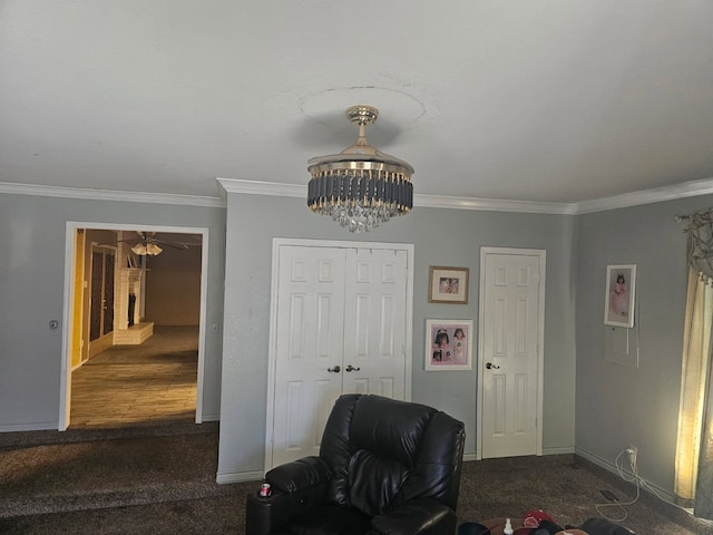 sitting room featuring ornamental molding, a notable chandelier, and baseboards