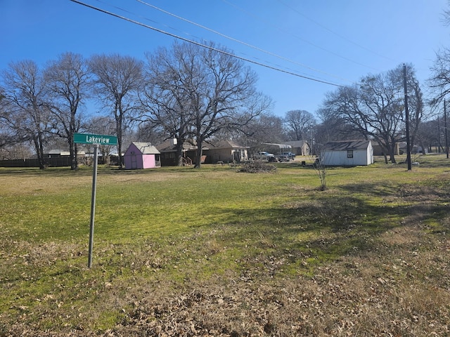 view of yard featuring an outbuilding and a shed