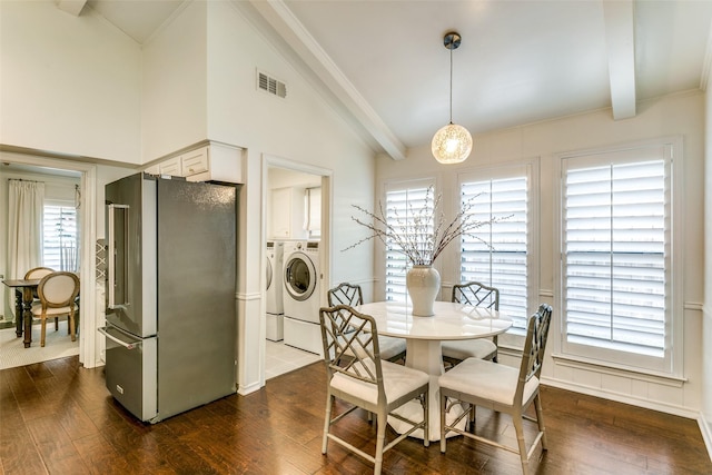 dining space with washer and clothes dryer, dark wood finished floors, and visible vents