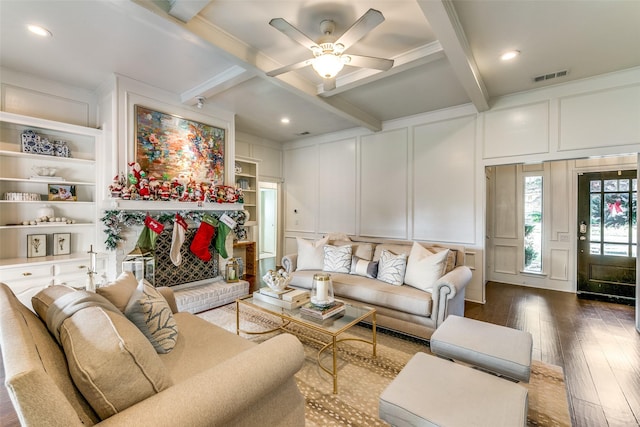 living area with visible vents, built in shelves, beam ceiling, dark wood-style floors, and a decorative wall