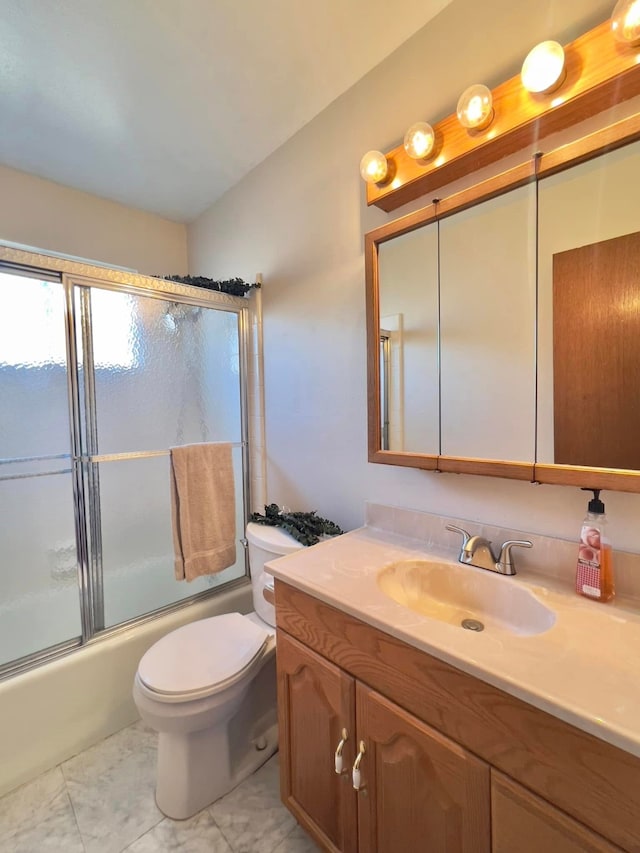 bathroom featuring toilet, bath / shower combo with glass door, and vanity