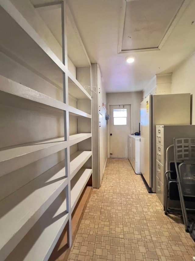 storage area with attic access and separate washer and dryer