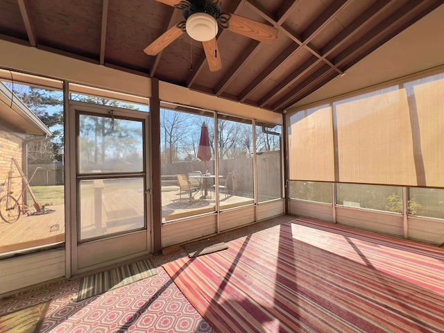 unfurnished sunroom featuring lofted ceiling and a ceiling fan