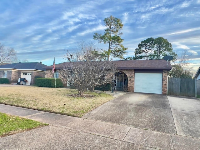 ranch-style house featuring a garage, brick siding, fence, driveway, and a front lawn