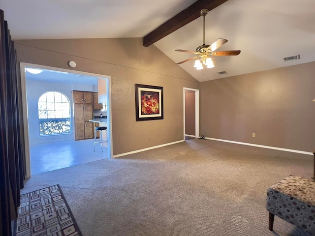 carpeted spare room with visible vents, ceiling fan, lofted ceiling with beams, and baseboards