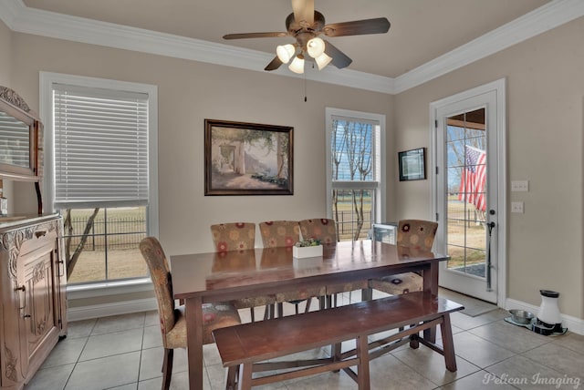 dining area featuring light tile patterned floors, ornamental molding, and a wealth of natural light