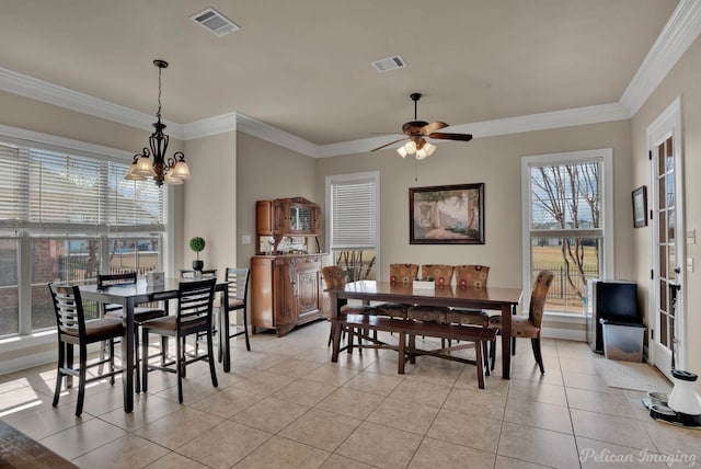 dining room featuring ceiling fan with notable chandelier, visible vents, crown molding, and light tile patterned flooring