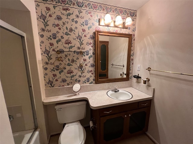 full bath with toilet, wallpapered walls, bath / shower combo with glass door, and vanity