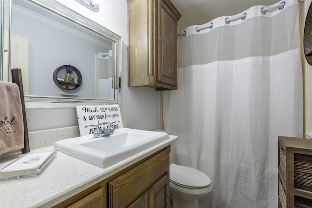 full bath featuring toilet, a shower with curtain, ornamental molding, and vanity