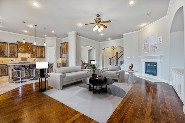 6055 The Resort Blvd, Fort Worth, TX 76179 - living room featuring arched walkways, hardwood / wood-style flooring, a ceiling fan, recessed lighting, and crown molding