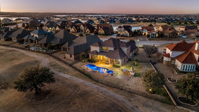 aerial view at dusk featuring a residential view