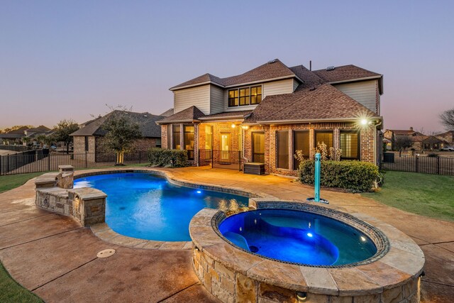 6055 The Resort Blvd, Fort Worth, TX 76179 - pool at dusk featuring a patio area and a pool with connected hot tub