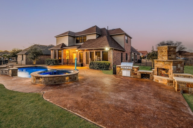 6055 The Resort Blvd, Fort Worth, TX 76179 - back of house featuring a patio area, an outdoor stone fireplace, brick siding, and an outdoor kitchen