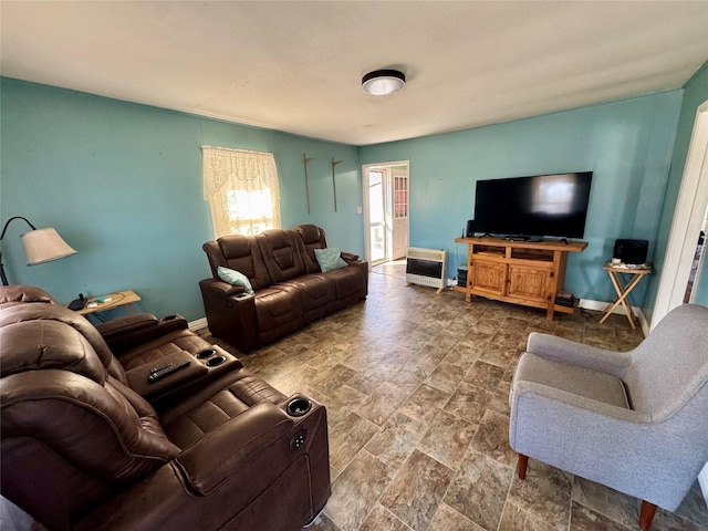 living room with stone finish floor and baseboards