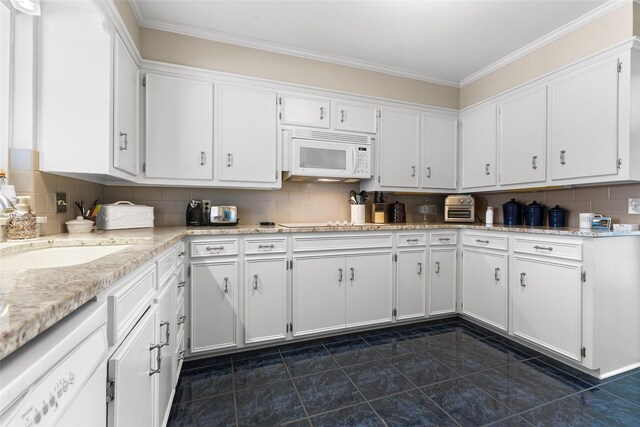 kitchen with ornamental molding, white appliances, white cabinets, and backsplash