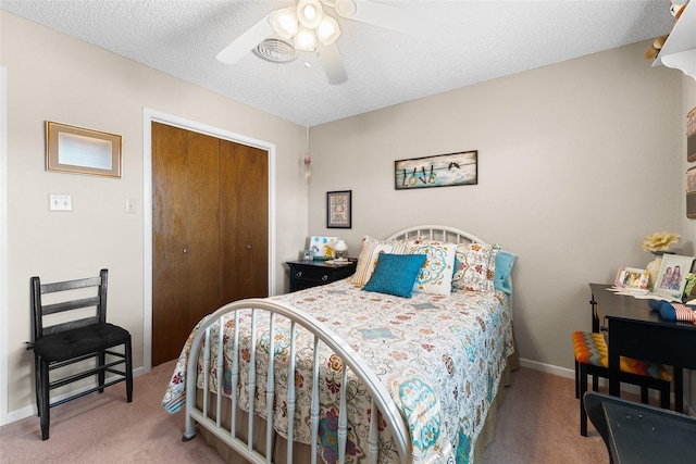 bedroom featuring a textured ceiling, ceiling fan, carpet floors, baseboards, and a closet