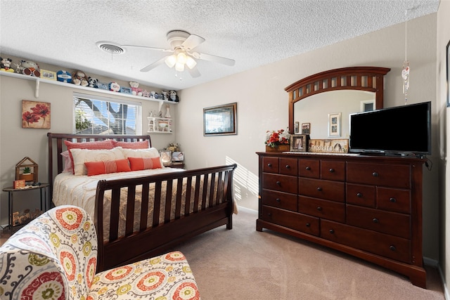 bedroom with a textured ceiling, ceiling fan, visible vents, and light colored carpet