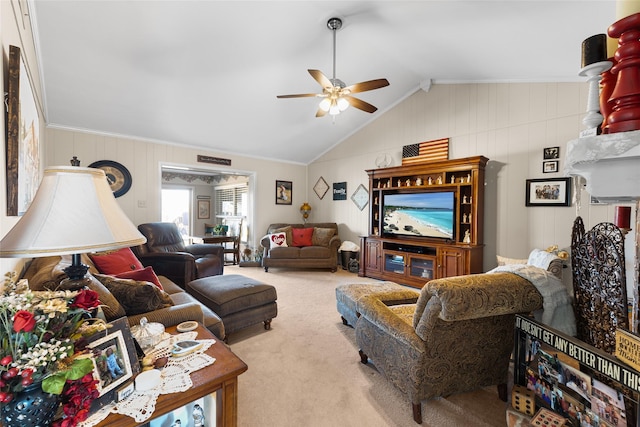 living area featuring vaulted ceiling, carpet flooring, and a ceiling fan