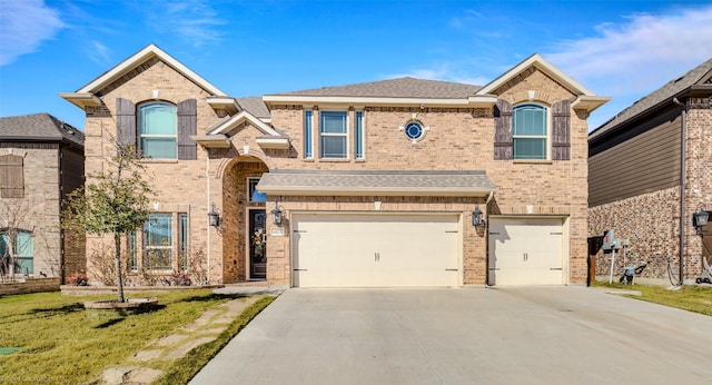 view of front of house with a garage, brick siding, a shingled roof, concrete driveway, and a front lawn