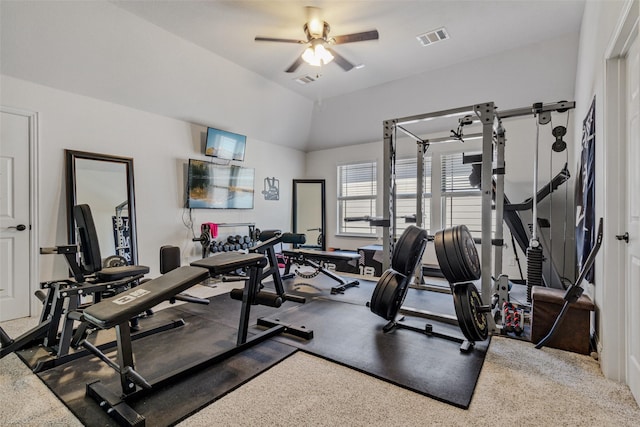 workout room featuring ceiling fan, vaulted ceiling, and visible vents