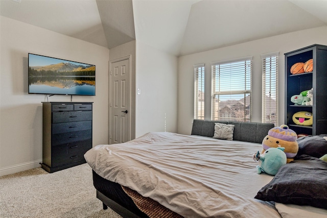 bedroom with carpet, vaulted ceiling, and baseboards