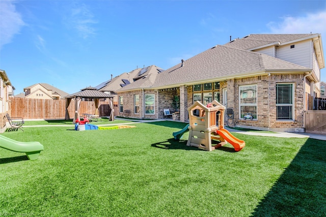 view of play area with a lawn, a gazebo, and a fenced backyard
