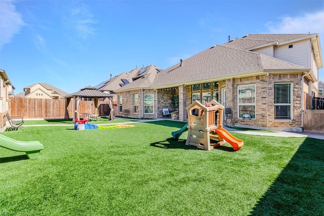 exterior space with a yard, a fenced backyard, a patio area, and a gazebo