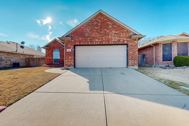 view of front of house featuring an attached garage, brick siding, fence, concrete driveway, and a front lawn