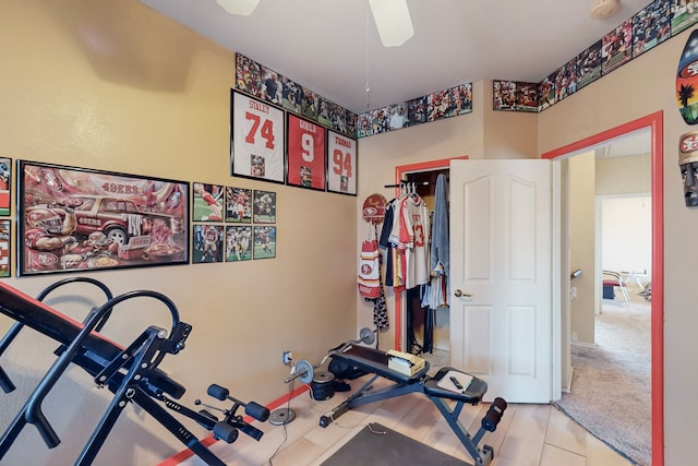 exercise area featuring a ceiling fan and tile patterned floors