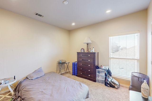 carpeted bedroom featuring recessed lighting, visible vents, and baseboards