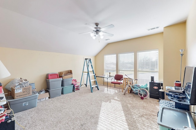 game room with a ceiling fan, carpet, visible vents, and vaulted ceiling