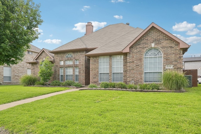 8502 Linda Vista Dr, Rowlett, TX 75088 - french country style house with brick siding, a front yard, and a chimney