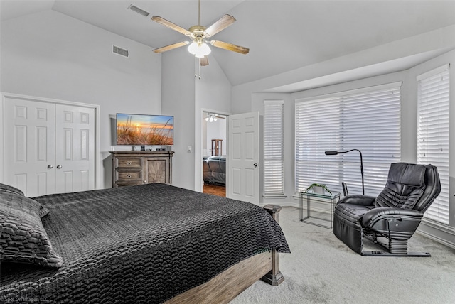 carpeted bedroom with lofted ceiling, ceiling fan, and visible vents