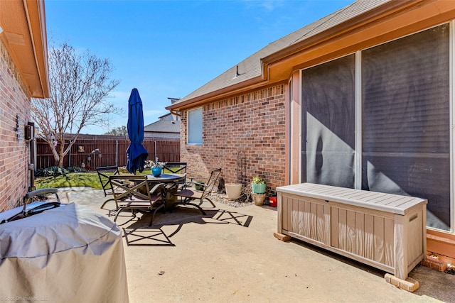 view of patio featuring outdoor dining space and fence