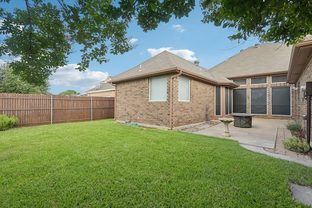 8502 Linda Vista Dr, Rowlett, TX 75088 - back of house featuring brick siding, a fenced backyard, a patio area, and a shingled roof