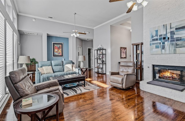 8502 Linda Vista Dr, Rowlett, TX 75088 - living area with a ceiling fan, wood finished floors, a brick fireplace, crown molding, and a towering ceiling