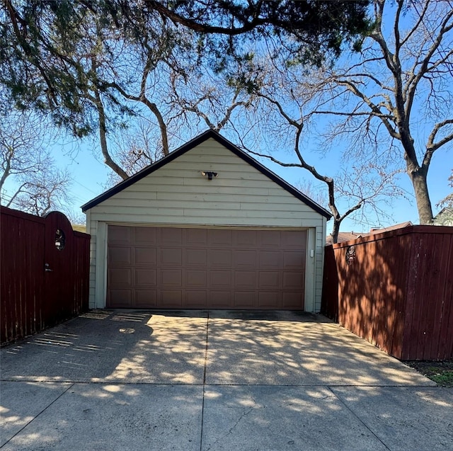 detached garage featuring a gate and fence