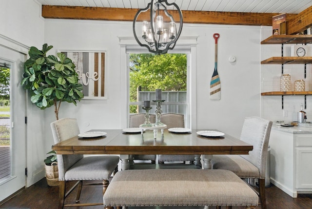 dining area featuring dark wood finished floors, a chandelier, and beamed ceiling