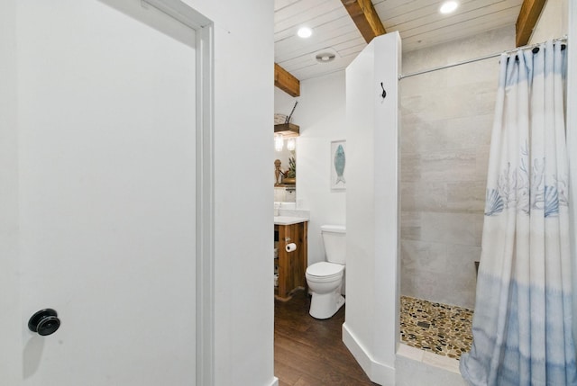 full bath featuring wood finished floors, vanity, a tile shower, toilet, and recessed lighting