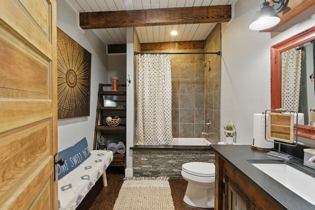 bathroom with wood finished floors, toilet, vanity, shower / tub combo with curtain, and beam ceiling