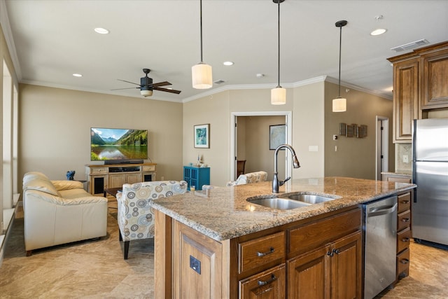 kitchen featuring visible vents, an island with sink, open floor plan, stainless steel appliances, and a sink