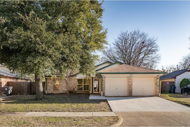 single story home with concrete driveway, brick siding, an attached garage, and fence