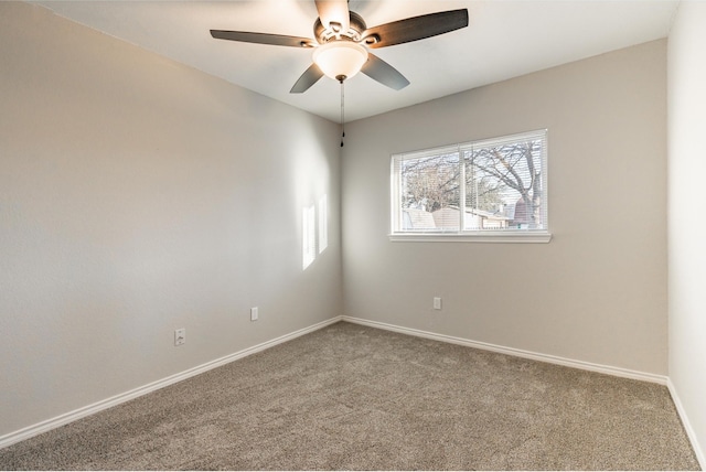 spare room featuring carpet floors, baseboards, and a ceiling fan