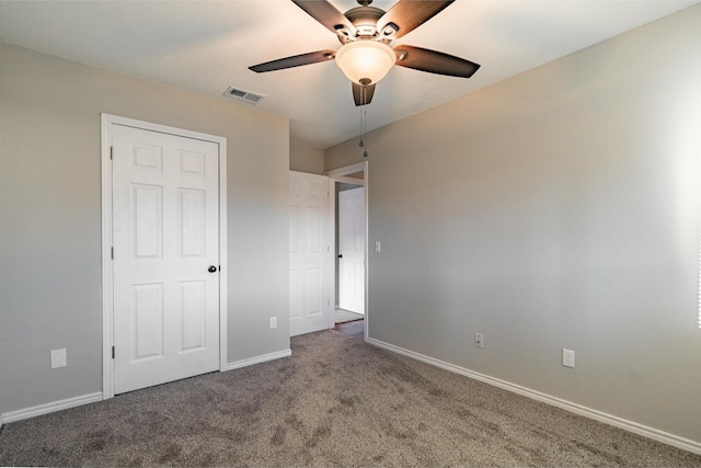 unfurnished bedroom featuring carpet, visible vents, ceiling fan, and baseboards